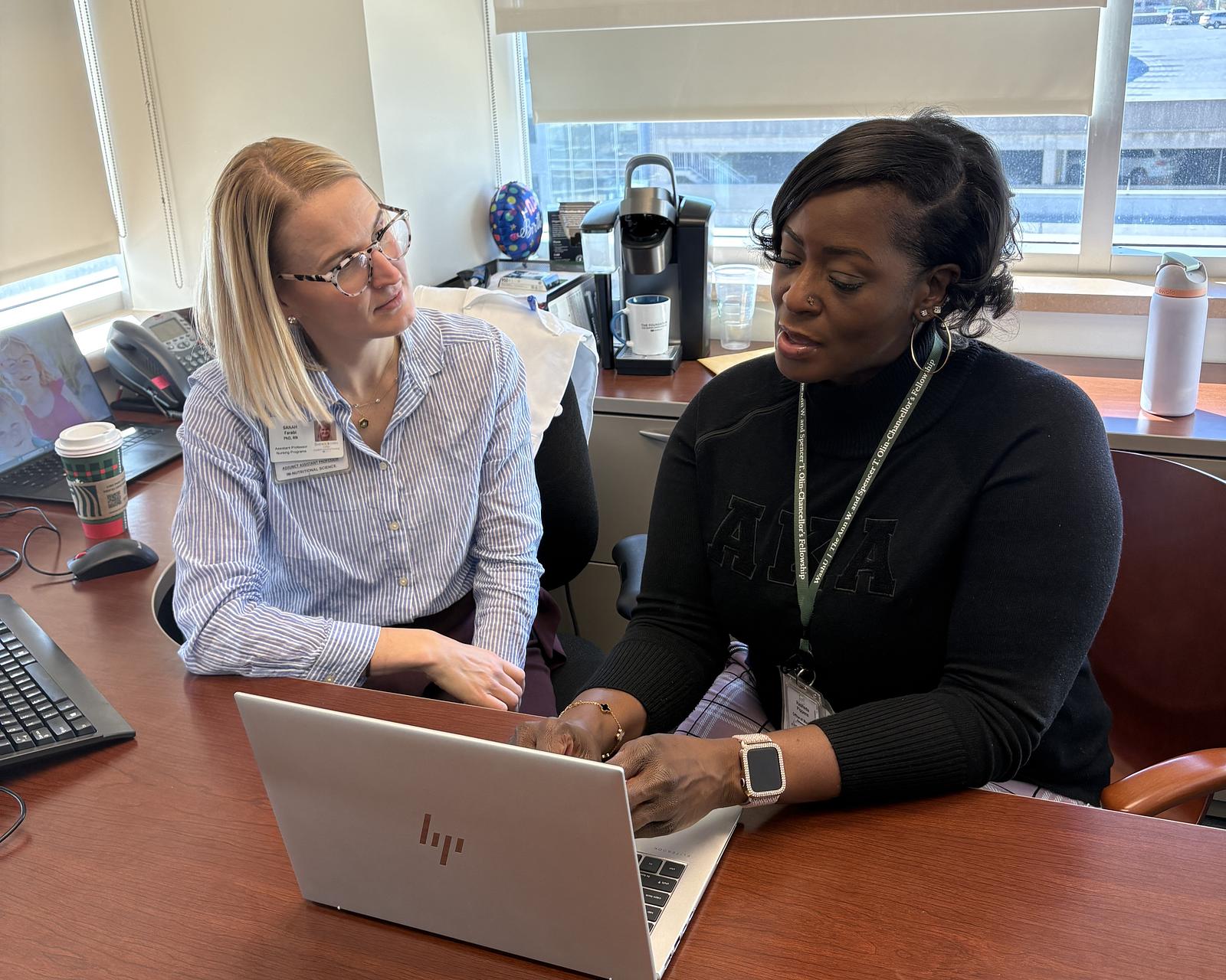 Goldfarb assistant professor Sarah Farabi (left) mentors PhD student Rasheda Pippens.