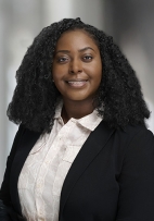 Tiffany Hammett's portrait smiling with a dark coat and white blouse.