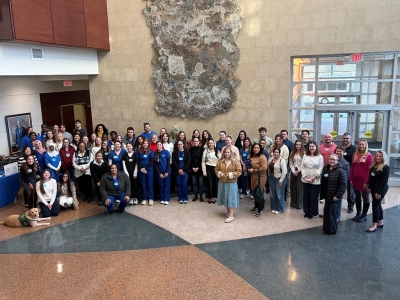 Many of the newest cohorts of BJC Full-Ride Scholars standing in the lobby at Goldfarb.