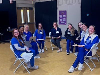Population Health students gather at BELIEVE Academy to talk with students and families about flu vaccines.